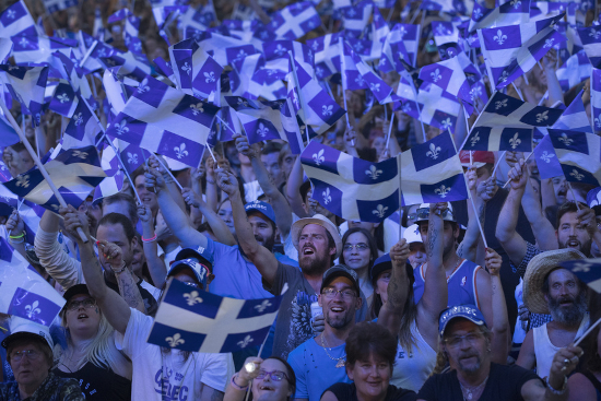 Quebec nationalists flying flags fervently